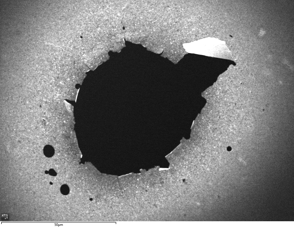 SE image of an electropolished TEM disc from a highly deformed, nanocrystalline Al-alloy, showing the brighter electron-transparent region around the central perforation.
