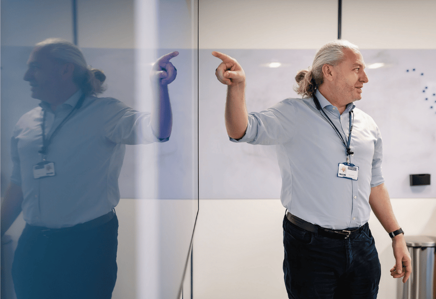 Employee of Oxford Instruments pointing to whiteboard in the office